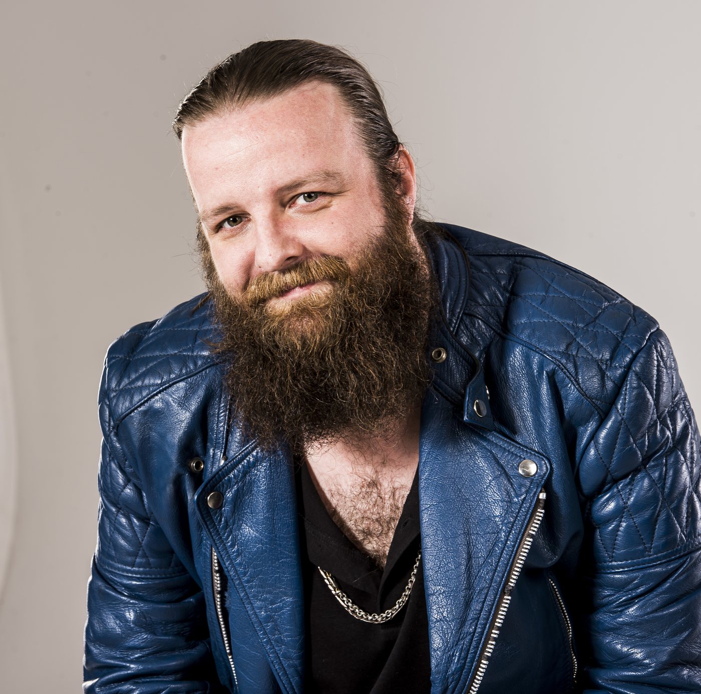 Jay Graham smiling, blue leather jacket