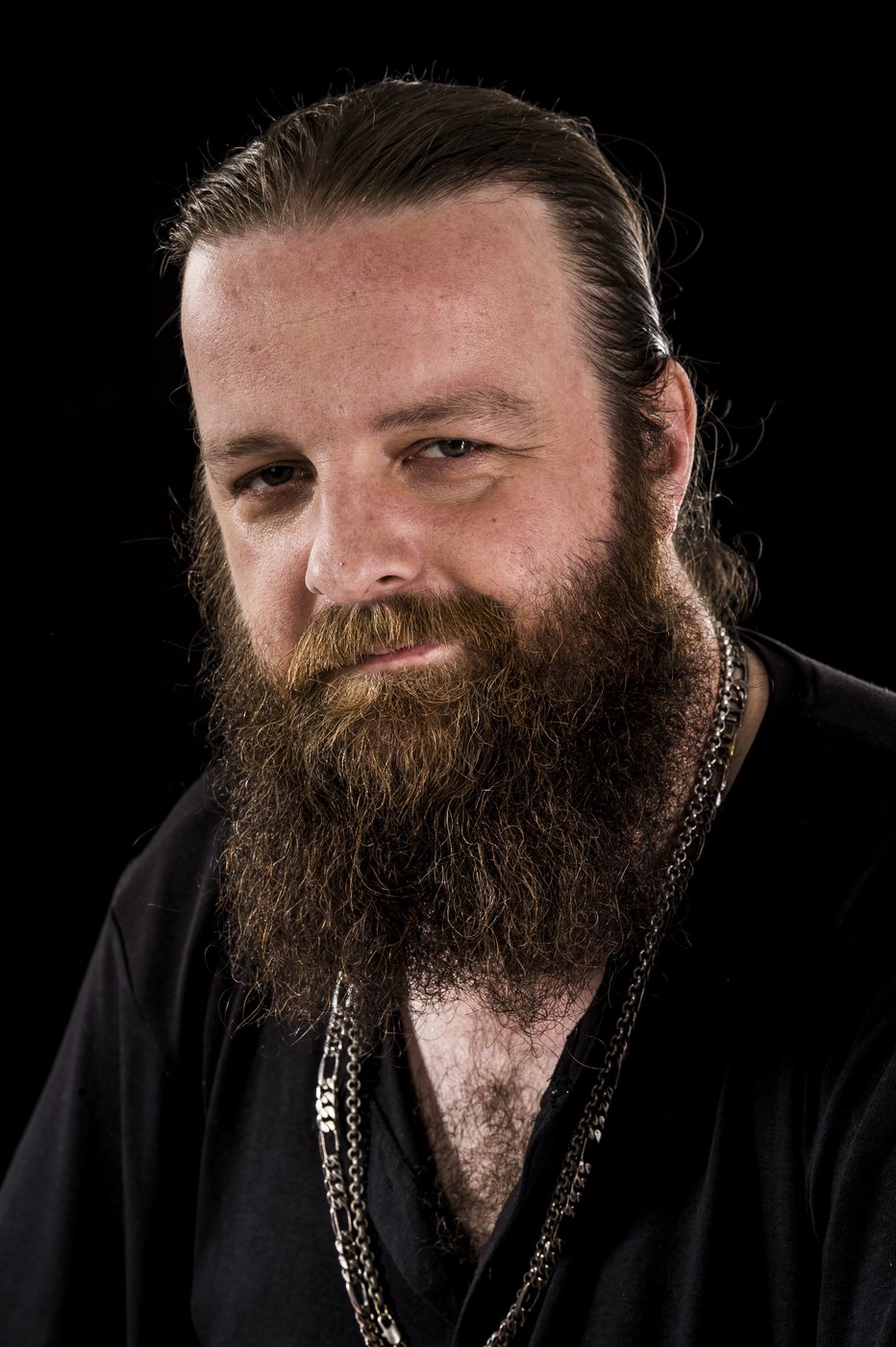 Jay Graham with a long beard, black backdrop