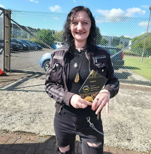 Debbie Lea Young holding her Best Actress award for Morning Jim