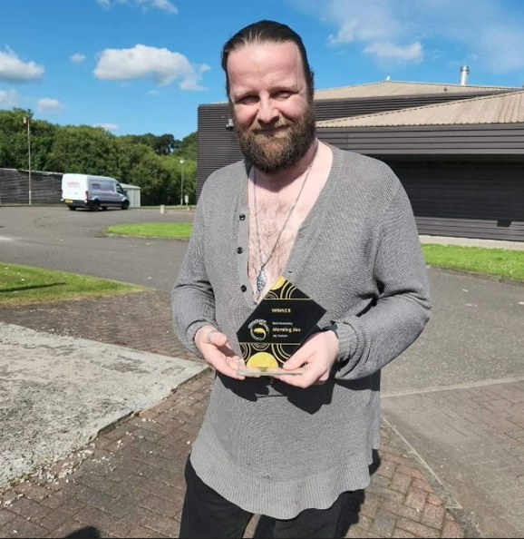 Jay Graham holding his Best Screenplay award for Morning Jim