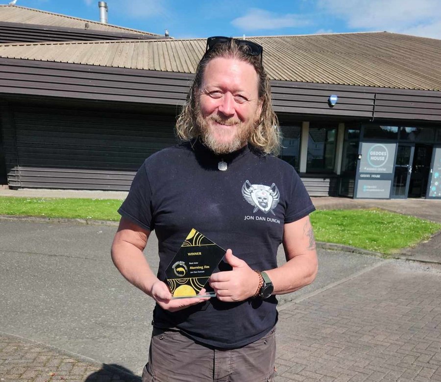 Jon Dan Duncan holding his Best Actor award for Morning Jim